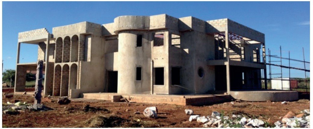 Multi-storey building under construction with concrete shell structure