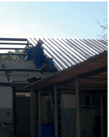 Roof installation in progress during building construction